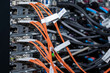 © Сергей Дудиков - Fiber optic cables and connectors plugged into servers. Modern IT and telecom infrastructure. Ideal for technology, networking, data transmission, and high-tech concepts.