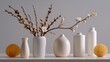 © Matcha_09 - Elegant display of minimalist vases and delicate floral arrangements featuring soft colors and textured elements on a clean shelf backdrop