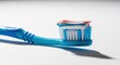 © MAJIDULISLAM - Toothbrush with red white and blue toothpaste on white surface
