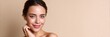 © Iryna - Smiling young caucasian female with natural makeup on beige background