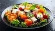 © GASTAN ALVARENDRA ST - Fresh Greek Salad with Feta Cheese and Olives on a Dark Plate.