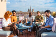 © unai - Diverse team brainstorming on a modern rooftop terrace
