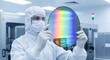 © Maryia - Microelectronics manufacturer semiconductor production, cleanroom engineer holding silicon wafer inside fabrication facility highlighting precision technology innovation and digital economy core
