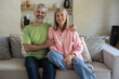 © zinkevych - Mature couple embracing relaxing sitting sofa feeling closeness at home