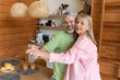 © zinkevych - Senior couple enjoying playful dance at home