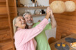 © zinkevych - Mature man and woman enjoying fun moment dancing in kitchen