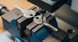 © MUHAMMAD - Machinist precision cuts keys on metalworking lathe in industrial workshop with machinery and tools visible in the background.