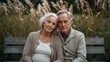 © Future Vision - Sitting senior couple leaning together on wooden park bench, wearing knit cardigans, pampas grass