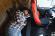 © Serhii - Truck driver sleeping resting inside truck cabin