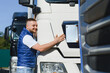 © Serhii - Happy young truck driver embracing his vehicle