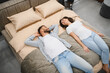 © Serhii - Young couple choosing bed at furniture store