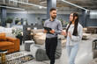 © Serhii - Client discussing furniture options with sales consultant