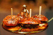 © 9parusnikov - Mini sesame burgers served on golden platter