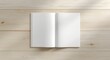 © The 2R Artificiality - Flat birds eye view of a pale wooden surface featuring an open magazine with an empty page for graphic mockup