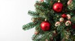 © CreativeBro - Christmas themed spruce branches close up decorated with red baubles and candy shaped sweets plus empty space