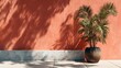 © horizon - Minimalist architectural detail depicts a terracotta wall with sharp palm frond shadows and a stone plinth in bright Mediterranean sunlight.