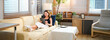 © Stella 16 - Woman relax on couch with tablet, online streaming with internet and reading ebook or watching film at home. Happy female person with technology, subscription and mobile app with break in living room