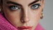 © Newleks - Female model with captivating green eyes using vibrant blue eyeliner and natural freckles, showcasing modern beauty standards and artistic makeup trends for fashion and cosmetic campaigns