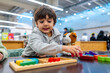 © unai - Boy playing with wooden puzzle and toy dog