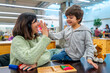 © unai - Mother and child high fiving playing puzzle game