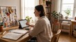 © Muhammad - woman working on digital tablet at wooden desk with notebook and plants in background for website, marketing, or presentation