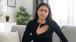 © Air stock - Woman Feeling Chest Pain and Stress While Sitting on Sofa at Home