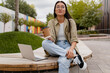 © mary_markevich - young pretty woman sitting in student campus co-working outside