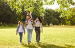 © Studio Romantic - Happy family walking together in park. Mother, father and children enjoy summer or spring green nature and fun healthy walk, dad carrying child on shoulders. Family love, stroll, bonding concept