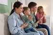 © New Africa - Family praying together on sofa at home