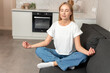 © brizmaker - Woman practicing mindfulness at home in a cozy living room