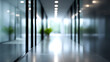 © Moddy - A modern office hallway with glass walls. It has a blurred background with soft light and plants