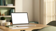 © bongkarn - White screen laptop with book and coffee on square wooden table across window a shelf in living room