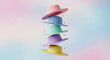 © Segera Studio - Multiple vibrant summer hats of different colors stacked vertically and floating against a gradient sky