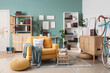 © Pixel-Shot - Comfortable armchair, book shelves, chest of drawers and bicycle in interior of living room