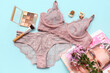 © Pixel-Shot - Composition with stylish lace underwear, cosmetics, magazine and flowers on color background