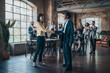 © Lomb - Inclusive onboarding process with diverse business women shaking hands during team introduction meeting
