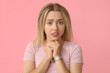 © Pixel-Shot - Embarrassed young woman on pink background
