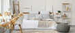 © Pixel-Shot - Interior of light bedroom with comfortable bed, pouf and workspace near window