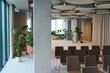 © Serhii - Modern conference room interior with sleek chairs and plants