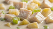© Aldi12 - Close-up of a creamy soup with chunks of chicken, potatoes, and celery in a shallow focus shot with warm, comforting tones.