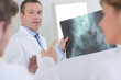 © auremar - Doctor holding xray, warding off questions