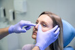 © Viacheslav Yakobchuk - ENT doctor examines nose of female patient before rhinoplasty surgery