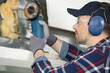 © auremar - worker using angle grinder to cut through metal framework