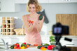 © auremar - woman recording video in her home kitchen