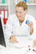 © auremar - woman worker with liquid tube writing result at science lab