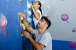 © auremar - delighted couple climbing up the wall