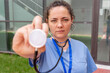 © StockMe - Healthcare professional holding stethoscope, offering medical assistance and care, representing health services