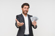 © InsideCreativeHouse - Business, man and happy with money in studio on white background for investment, finance and stock market. Young man, portrait and smile for cash for trading, cryptocurrency and winning returns
