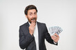 © InsideCreativeHouse - Rich pleased businessman financial consultant banker in suit waving money dollar cash banknotes bills like a fan, success business career, lottery winner, big income wealth isolated white background
