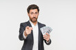 © InsideCreativeHouse - Prosperity wealth rich Caucasian businessman CEO millionaire manager blogger in formalwear suit holding money, sale financial courses looking at camera isolated in white background. Credit concept